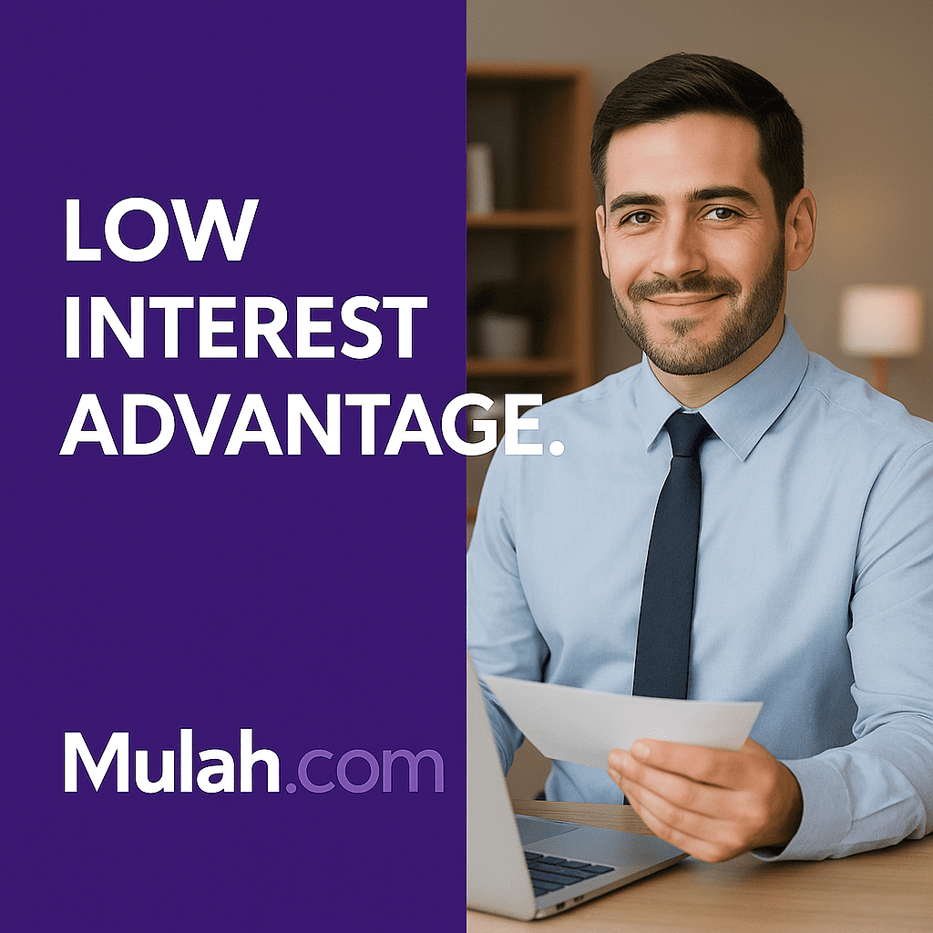 Professional businessman sitting at a desk with a laptop and holding a document beside bold text that reads “Low Interest Advantage,” promoting Mulah.com’s low-rate business credit card.