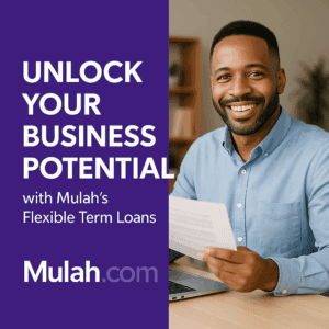 Smiling Black male business professional sitting at a desk holding documents beside text reading “Unlock Your Business Potential with Mulah’s Flexible Term Loans,” promoting Mulah.com’s business funding solutions.