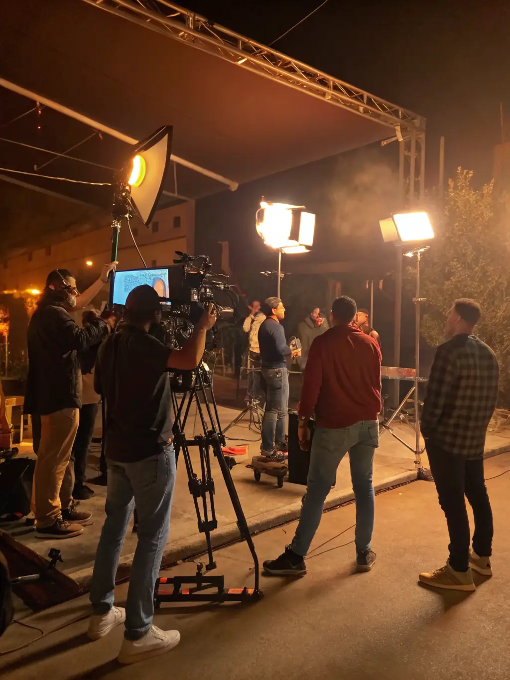 A vibrant image of a film set, showcasing various crew members working together, emphasizing the collaborative nature of film production and the need for funding to support such projects.