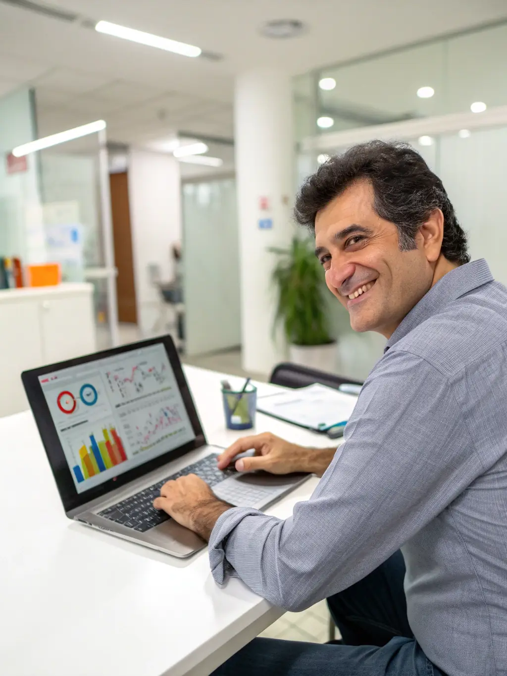 An image of a dry cleaning business owner smiling and confidently managing their business finances on a tablet.