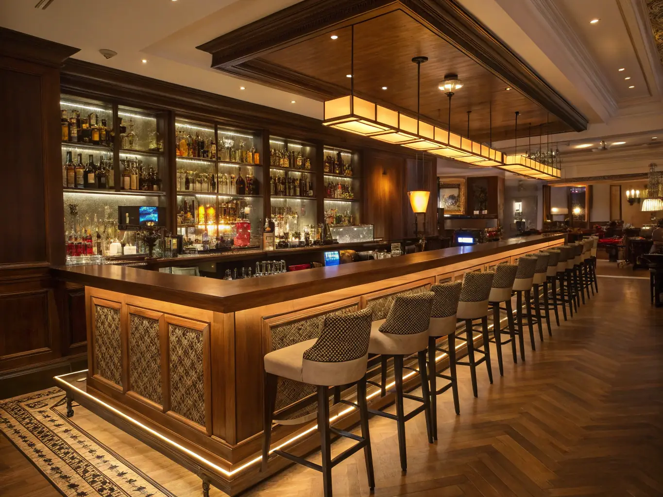A vibrant photograph of a modern bar interior, showcasing a well-stocked bar with various liquor bottles and a bartender mixing a cocktail. The lighting is warm and inviting, creating a lively atmosphere.