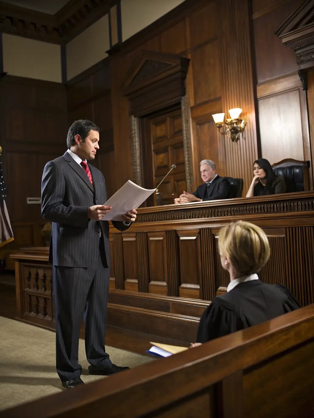 A detective presenting evidence in a courtroom, representing the culmination of investigative work and the need for legal resources.