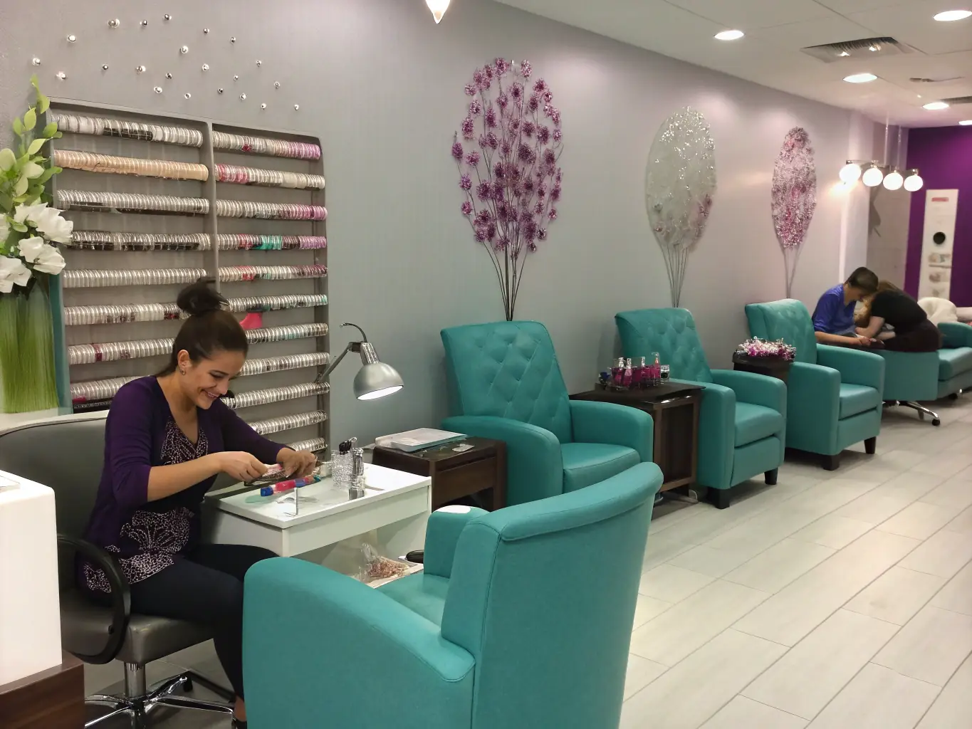 A modern nail salon interior with clients receiving manicures and pedicures, showcasing a clean and inviting atmosphere, representing the potential for growth and success with the right funding.