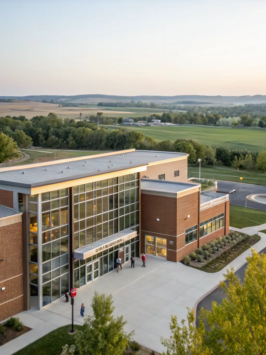 An exterior shot of a school building with new signage and landscaping, demonstrating the visible improvements made possible through OnDeckClone's funding.