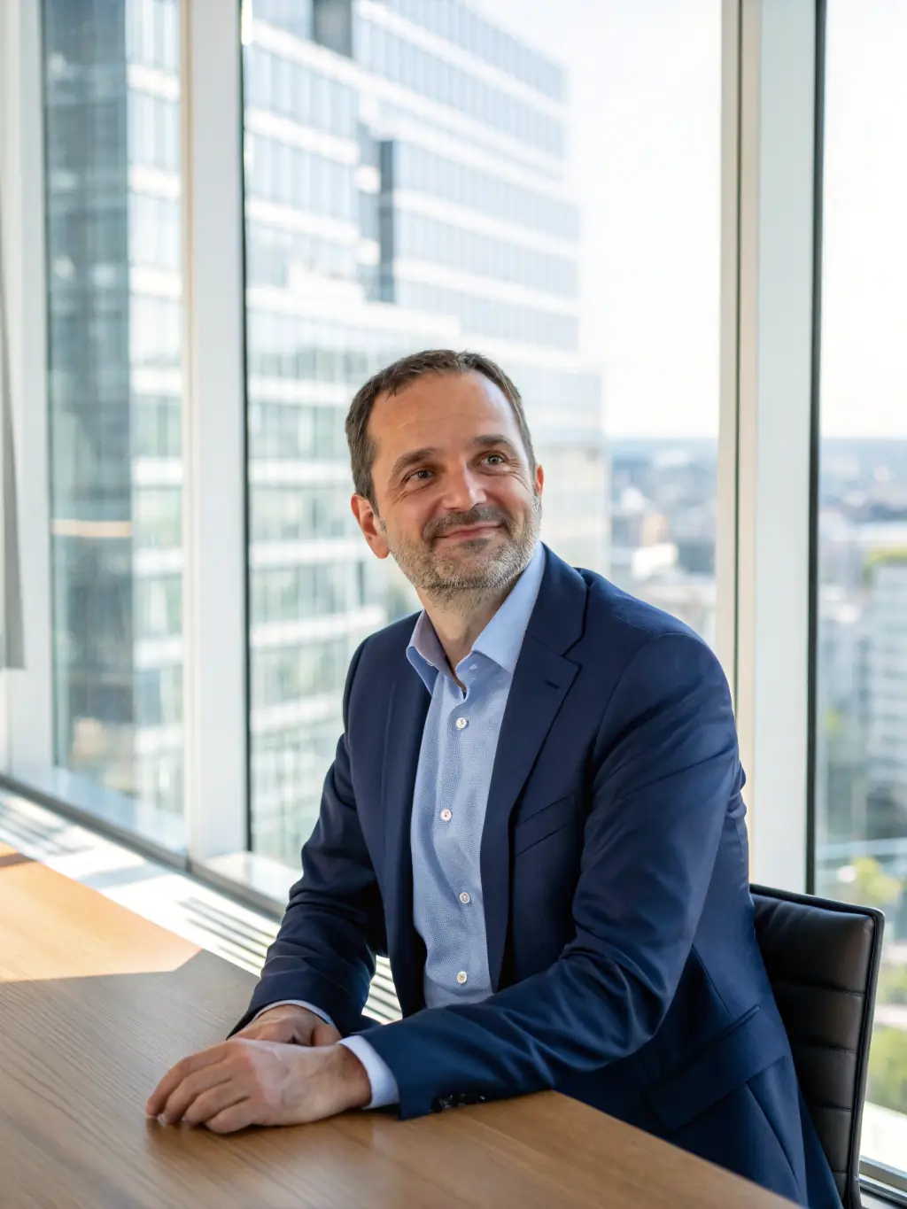 A professional image of a home healthcare agency owner smiling confidently while reviewing financial documents in a modern office setting. The scene should convey trust and success.
